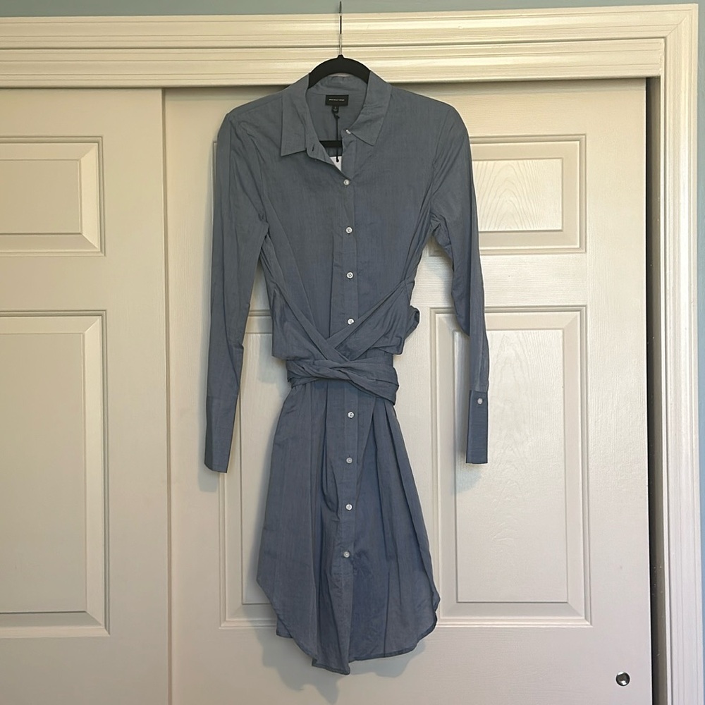 Shirt dress in light blue with wrap around tie. Size small. New.